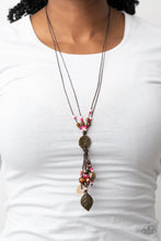 Load image into Gallery viewer, An earthy assortment of Pale Rosette and Fuchsia Fedora seed beads, rustic brass discs, and wooden accents glide along lengthy strands of brown cording that knot around a hammered brass disc. Tassels of matching beads, a white shell-like accent, floral silver bead, and brass leaf charm dance from the bottom, adding playful movement to the free-spirited display. Features an adjustable clasp closure.
