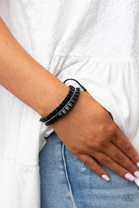 Infused with a dainty strand of silver ball chain, a ribbon of black leather gathers into a pleated bracelet around the wrist for a rustic flair. Features an adjustable sliding knot closure.