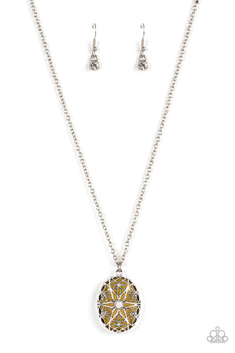 Dotted with a glitzy white rhinestone center, studded and smooth floral filigree detail blooms across the front of an oversized yellow cat's eye stone, resulting in a whimsical pendant at the bottom of a silver chain. Features an adjustable clasp closure.  Sold as one individual necklace. Includes one pair of matching earrings.