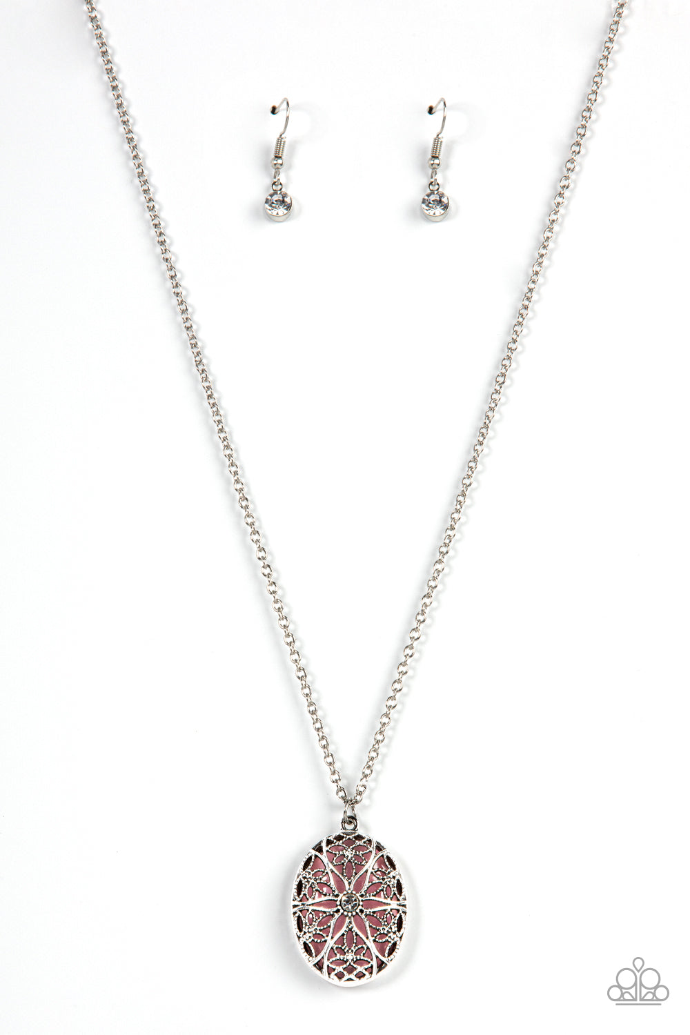 Dotted with a glitzy white rhinestone center, studded and smooth floral filigree detail blooms across the front of an oversized pink cat's eye stone, resulting in a whimsical pendant at the bottom of a silver chain. Features an adjustable clasp closure.