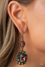 Load image into Gallery viewer, Dainty hematite rhinestones and teardrop oil spill gems fan out from an oversized oil spill emerald cut gem at the bottom of a solitaire oval oil spill gem, resulting in a glamorously glitzy lure. Earring attaches to a standard fishhook fitting.
