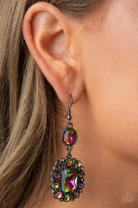 Dainty hematite rhinestones and teardrop oil spill gems fan out from an oversized oil spill emerald cut gem at the bottom of a solitaire oval oil spill gem, resulting in a glamorously glitzy lure. Earring attaches to a standard fishhook fitting.