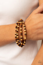 Load image into Gallery viewer, Varying in natural wooden finishes, stretchy strands of dainty wooden beads attach to a single row of oversized wooden beads around the wrist for an earthy spin on the homespun trend.
