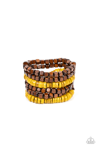 Stretchy strands of brown wooden cube beads and distressed yellow wooden discs are held in place by rectangular wooden frames, resulting in an earthy centerpiece around the wrist.