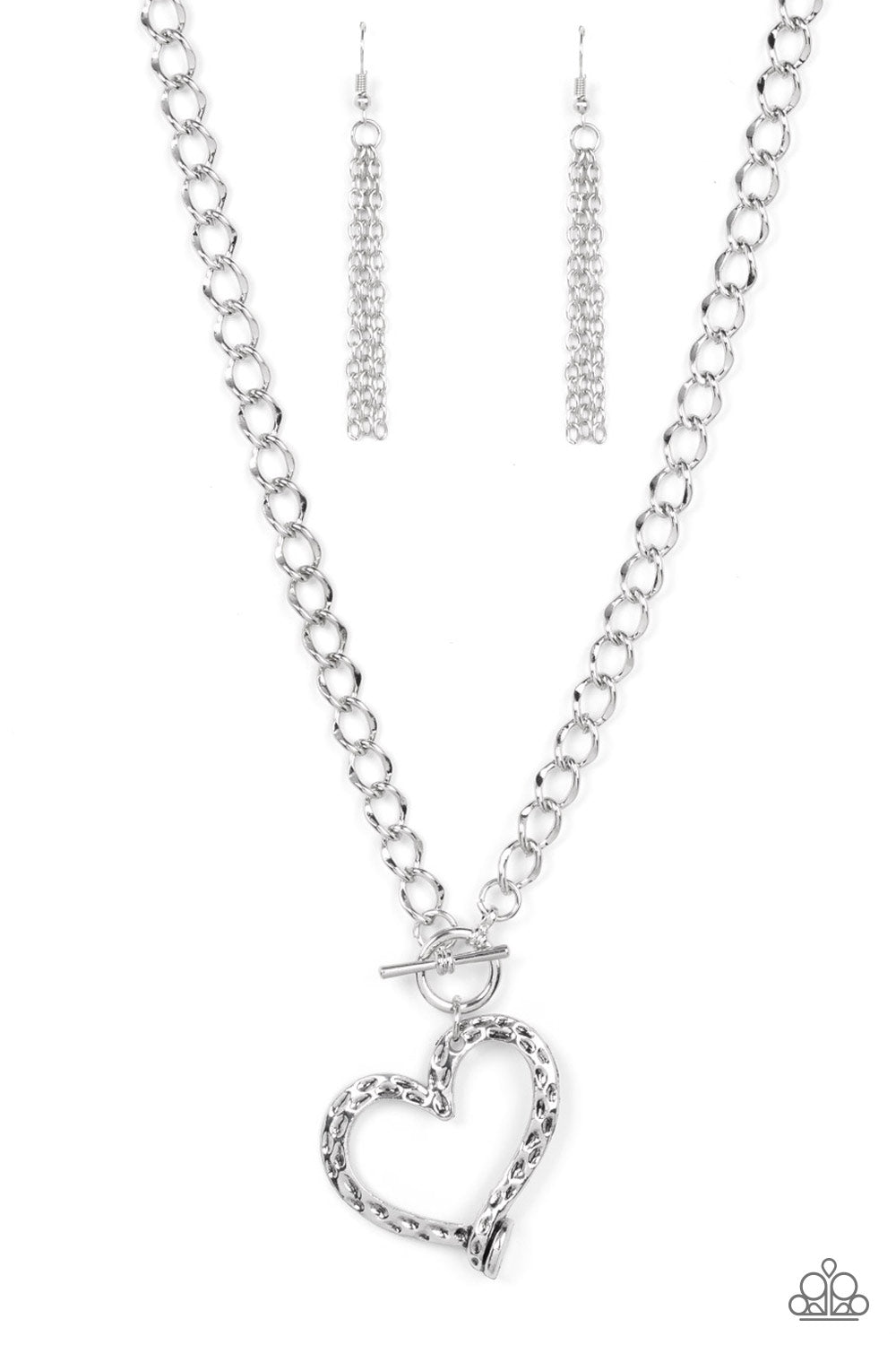 A hammered silver heart frame gently twists from a toggle closure at the bottom of a chunky silver chain, resulting in a romantically rustic pendant. Features a toggle closure.