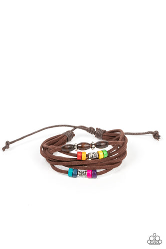 An earthy assortment of silver beads, textured silver accents, and multicolored wooden beads glides along layered strands of rustic brown suede, resulting in a whimsically layered centerpiece. Features an adjustable sliding knot closure. 