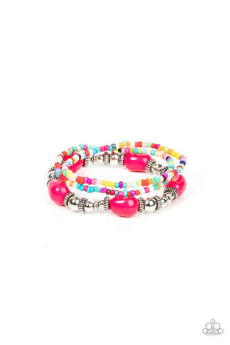 A pair of multicolored seed beaded stretchy bracelets joins a stretchy strand of shiny silver beads, textured silver accents, and faceted pink beads around the wrist, creating colorful layers. 
