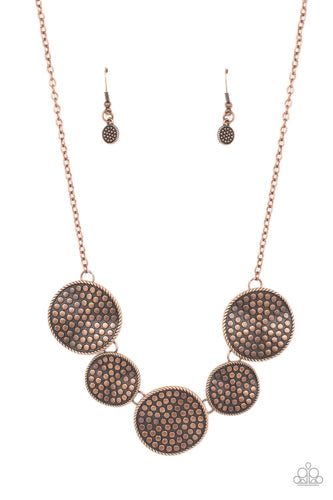 Embossed in a dotted motif, a rustic collection of warped copper discs ruggedly links below the collar for an artisan inspired fashion. Features an adjustable clasp closure.