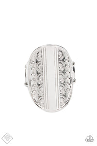 An oval shaped disc is divided down the center by a smooth band of silver. Silver studs and embellished texture are mirrored on either side of the divide as the band curves across the finger for an understated yet timeless finish. Features a stretchy band for a flexible fit.  Sold as one individual ring.  Fashion Fix