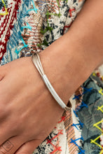 Load image into Gallery viewer, A contemporary curved silver cylinder slides along smooth strands of natural brown cording as they wrap around the wrist. The cording is capped in sleek silver fittings for a modern polished finish. Features a magnetic closure.  Sold as one individual bracelet.  Fashion Fix
