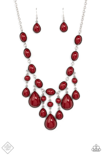 A row of deep red oval beads set in antiqued silver frames connect end to end across the collar. Falling from the center of the design, a trio of opulently grand teardrop beads coalesce with streams of smaller red round and teardrop beads creating a flirty fringe and dramatic allure. Features an adjustable clasp closure.  Sold as one individual necklace. Includes one pair of matching earrings.