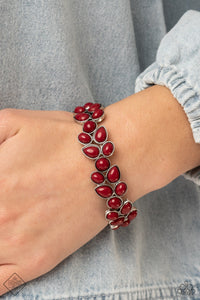 A flourishing collection of red oval, round, and teardrop beads coalesce into abstract floral-inspired frames. The enchanting frames, threaded along stretchy bands, add a vivacious pop of color around the wrist.  Sold as one individual bracelet.