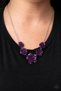 A dainty collection of primrose and floral plum frames delicately connect below the collar, blooming into a seasonal centerpiece. Features an adjustable clasp closure.