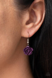 A dainty collection of primrose and floral plum frames delicately connect below the collar, blooming into a seasonal centerpiece. Features an adjustable clasp closure.