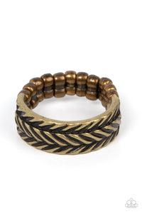 Etched in rustic patterns, slanted rows of chevron-like textures alternate across a dainty brass band. The centermost row is raised, adding 3-dimensional detail to the rustic centerpiece. Features a dainty stretchy band for a flexible fit. 