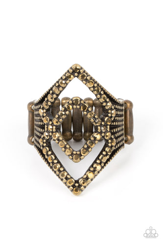 A pair of aurum encrusted diamond shaped frames stacks atop studded brass fittings, culminating into an edgy sparkle. Features a stretchy band for a flexible fit.