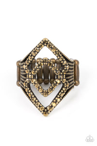 A pair of aurum encrusted diamond shaped frames stacks atop studded brass fittings, culminating into an edgy sparkle. Features a stretchy band for a flexible fit.
