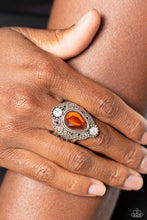 Load image into Gallery viewer, Glassy white rhinestones flank a mystically oversized burnt orange teardrop atop folds of studded and filigree filled silver ruffles, culminating into an enchanting centerpiece atop a decorative silver band. Features a stretchy band for a flexible fit.
