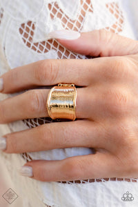 Wavy gold bars border a flattened gold frame that is etched with subtle textures, resulting in a reflective shimmer around the finger. Features a stretchy band for a flexible fit.  Sold as one individual ring.  New Kit Fashion Fix