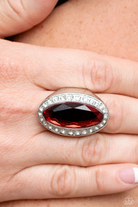 Bordered by a glitzy ring of white rhinestones, an oblong red gem embellishes the center of a dramatically oversized silver frame for a blinding finish. Features a stretchy band for a flexible fit.