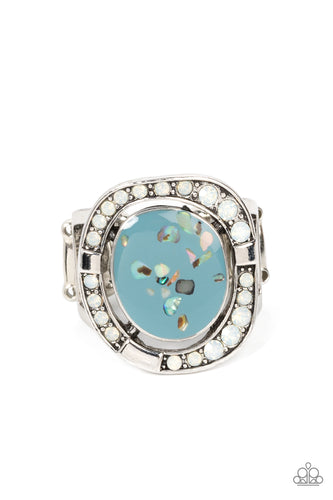Flecked in shell-like accents, an asymmetrical Spring Lake frame seemingly floats inside an imperfectly round silver frame dotted in sections of opal white rhinestones and shiny silver accents, invoking a beach inspired fashion atop the finger. Features a stretchy band for a flexible fit.