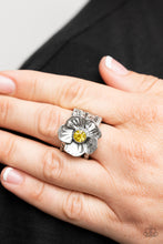 Load image into Gallery viewer, Textured silver petals gently gather around a sparkling yellow rhinestone center, blooming into a dazzling floral centerpiece atop the finger. Features a stretchy band for a flexible fit. 
