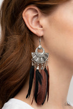 Load image into Gallery viewer, Oversized black and brown feathers swing from the bottom of an ornately hammered and stacked silver frame, resulting in a flirtatiously colorful fringe. Earring attaches to a standard fishhook fitting. 
