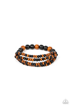 Load image into Gallery viewer, Stretchy strands of dainty brown and black wooden beads attach to a single strand of oversized brown and black wooden beads, resulting in colorful layers around the wrist.
