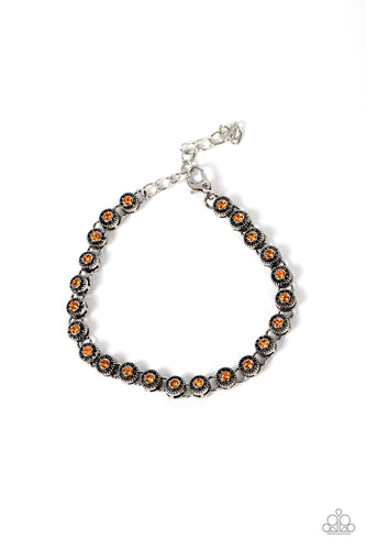 Featuring studded silver fittings, a dainty collection of orange rhinestones delicately connects with antiqued silver links for a subtle shimmer around the wrist. Features an adjustable clasp closure.