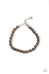 Featuring studded silver fittings, a dainty collection of orange rhinestones delicately connects with antiqued silver links for a subtle shimmer around the wrist. Features an adjustable clasp closure.