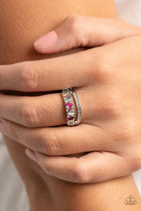 Infused with a timeless band of white rhinestones, a dainty collection of trapezoidal light pink, dark pink, and iridescent rhinestones staggers across the finger for a glamorously layered look. Features a dainty stretchy band for a flexible fit.