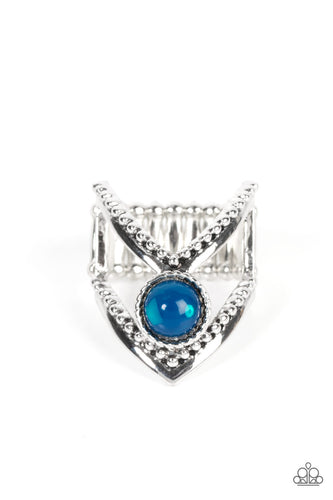A glassy Mykonos Blue bead balances between arching silver bars featuring smooth and studded details, resulting in an edgy frame around the finger. Features a stretchy band for a flexible fit.