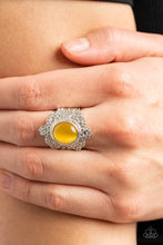 Load image into Gallery viewer, Embossed in an enchanting heart motif, a frilly silver frame is adorned with a dreamy yellow cat&#39;s eye stone center for a magical pop of color atop the finger. Features a stretchy band for a flexible fit.
