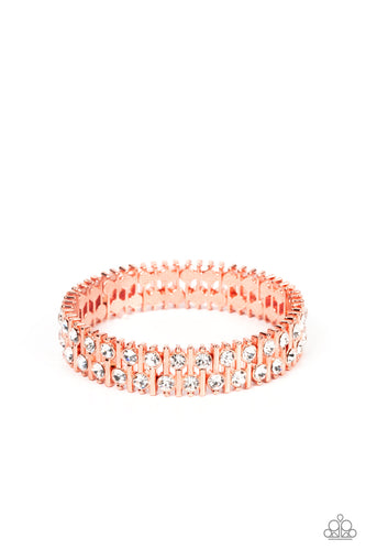 Attached to shiny copper bars, a staggered display of solitaire white rhinestones alternates along a stretchy band around the wrist for an unexpected pop of shimmer around the wrist.
