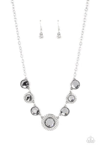 Oversized smoky gems alternate with matching gems bordered in rings of glassy white rhinestones below the collar, resulting in a spellbinding sparkle at the bottom of a classic silver chain. Features an adjustable clasp closure. 