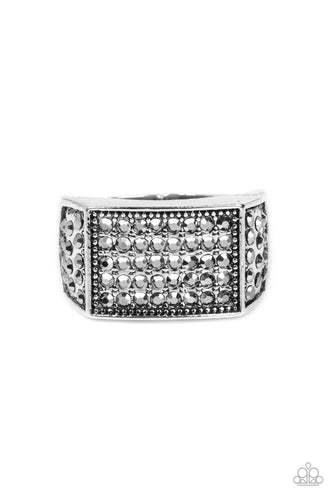 The front of a rectangular silver frame is encrusted in sections of hematite rhinestones, resulting in a smoldering centerpiece atop the finger. Features a stretchy band for a flexible fit.