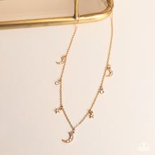 Load image into Gallery viewer, Dotted with dainty white rhinestones, a cosmic collection of gold moon and star charms swings from a dainty gold chain below the collar. Solitaire white rhinestones sparkle in between the charms, adding additional sparkle to the piece. Features an adjustable clasp closure Featured inside The Preview at GLOW! 
