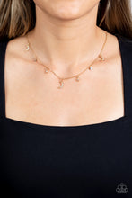 Load image into Gallery viewer, Dotted with dainty white rhinestones, a cosmic collection of gold moon and star charms swings from a dainty gold chain below the collar. Solitaire white rhinestones sparkle in between the charms, adding additional sparkle to the piece. Features an adjustable clasp closure Featured inside The Preview at GLOW! 
