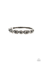 Load image into Gallery viewer, Dotted with dainty black rhinestones, geometrically patterned silver frames alternate across the front of a bangle-like bracelet for an edgy pop of shimmer. Features a hinged closure. 
