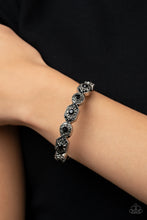 Load image into Gallery viewer, Dotted with dainty black rhinestones, geometrically patterned silver frames alternate across the front of a bangle-like bracelet for an edgy pop of shimmer. Features a hinged closure. 
