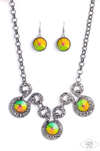 Three dramatically oversized oil spill rhinestones are nestled into three textured gunmetal fittings that are connected by oval gunmetal rings, creating a brilliant statement piece. Features an adjustable clasp closure. Due to its prismatic palette, color may vary. 