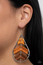 Load image into Gallery viewer, An ombré of orange and brown threads decoratively weave along arched silver bars inside of a shiny silver teardrop, resulting in an earthy lure. Earring attaches to a standard fishhook fitting. 
