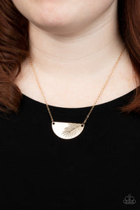 Suspended between the center of a dainty gold chain, a glistening gold half moon plate is stamped in an antiqued palm leaf for a seasonal flair. Features an adjustable clasp closure.