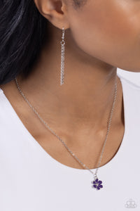 Painted in a plum finish, hammered silver petals delicately curl around a studded silver center at the bottom of a dainty silver chain for a rustically romantic finish. Features an adjustable clasp closure. 