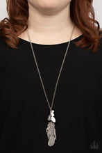Load image into Gallery viewer, Infused with glassy and acrylic white beads, an oversized silver feather swings from the bottom of an extended silver chain for a fearlessly free-spirited fashion. Features an adjustable clasp closure. 
