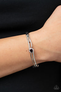 Ribbons of shiny silver and white rhinestone encrusted silver bars wrap around a glittery purple rhinestone center, resulting in a timeless shimmer atop a versatile bangle-like bracelet. Features a hinge closure.