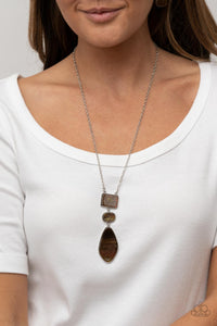 Featuring an iridescent shimmer, rectangular, oval, and asymmetrical multicolored brown shell-like accents link from the bottom of an extended silver chain for a beach inspired fashion. Features an adjustable clasp closure. 