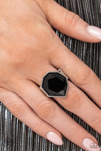 Load image into Gallery viewer, A sleek black bead featuring sharp geometric angles and a defaced surface is pressed into a studded silver frame. The faceted edges catch and reflect the light for an edgy centerpiece atop the finger. Features a stretchy band for a flexible fit.  Sold as one individual ring.  New Kit Fashion Fix
