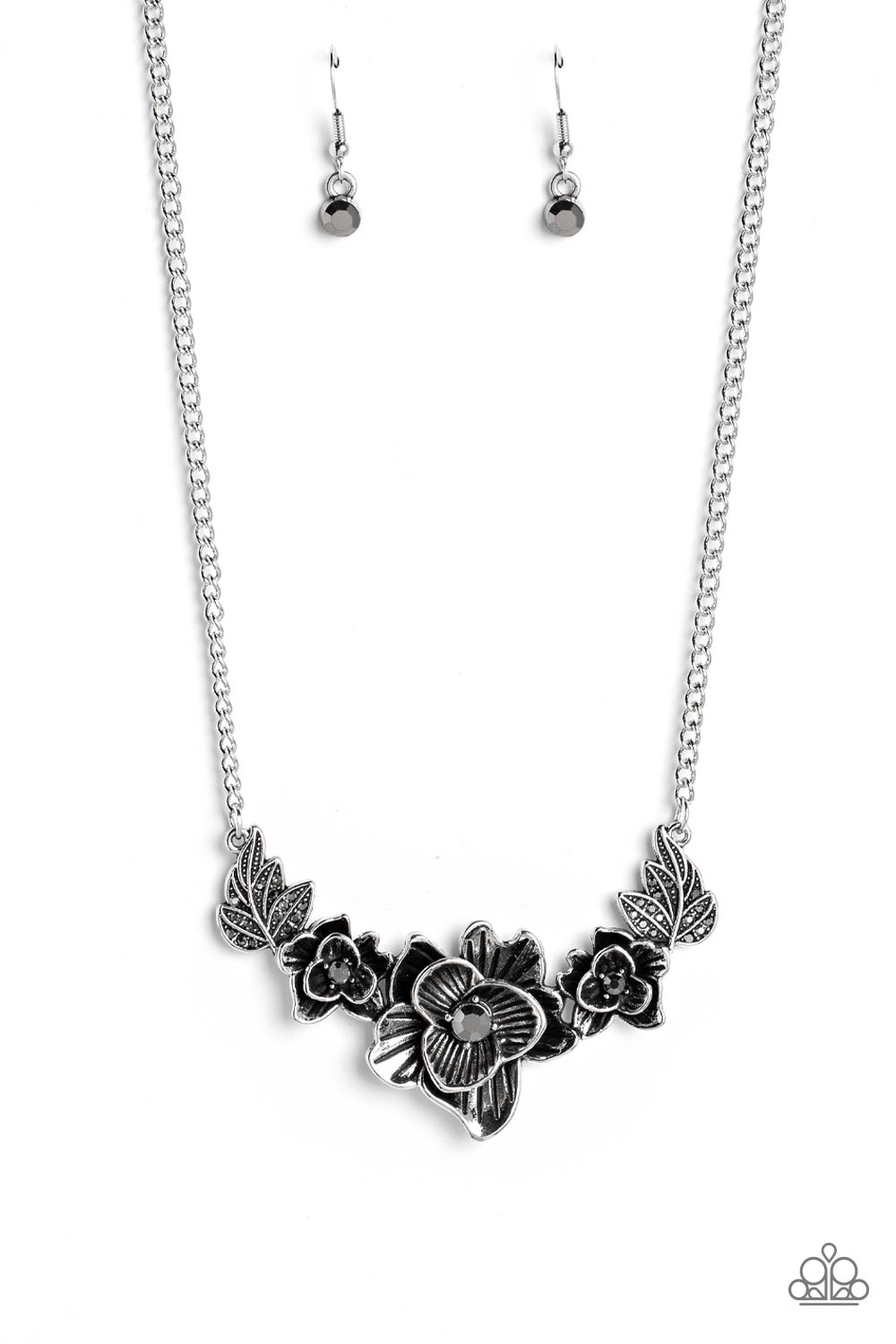 Dainty hematite rhinestones are sprinkled across leafy silver frames that branch out from a trio of mismatched silver floral frames dotted in dainty silver studs and hematite rhinestones, resulting in a beautiful botanical centerpiece below the collar. Features an adjustable clasp closure.