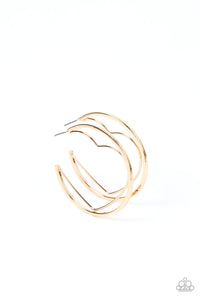 A gold wire heart is encircled in an oversized gold hoop, resulting in a heart-stopping shimmer. Earring attaches to a standard post fitting. Hoop measures approximately 2" in diameter.